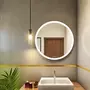 round mirror with white lights above washbasin