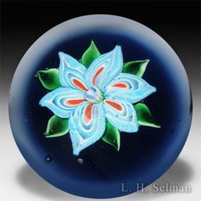 Ronald Hansen blue, white and red flower on blue ground paperweight. by Ronald Hansen