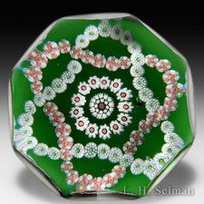 Antique Baccarat entwined double trefoil on translucent green ground faceted paperweight. by Baccarat Antique