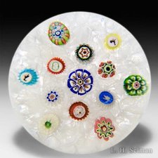 Antique Baccarat scattered millefiori on white muslin paperweight. by Baccarat Antique