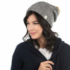 A woman wearing a Hope Slouch Hat with a pom pom.