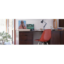 90 Mini Mini Desk Lamp and an Eames Molded Fiberglass Dowel Leg Side Chair at desk in a home office setting