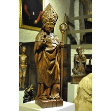 A LATE 15TH CENTURY NORMAN OAK SCULPTURE OF A BISHOP / SAINT. CIRCA 1480.